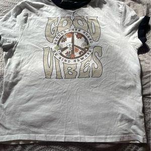 White blouse with black with a symbol of Peace and flowers